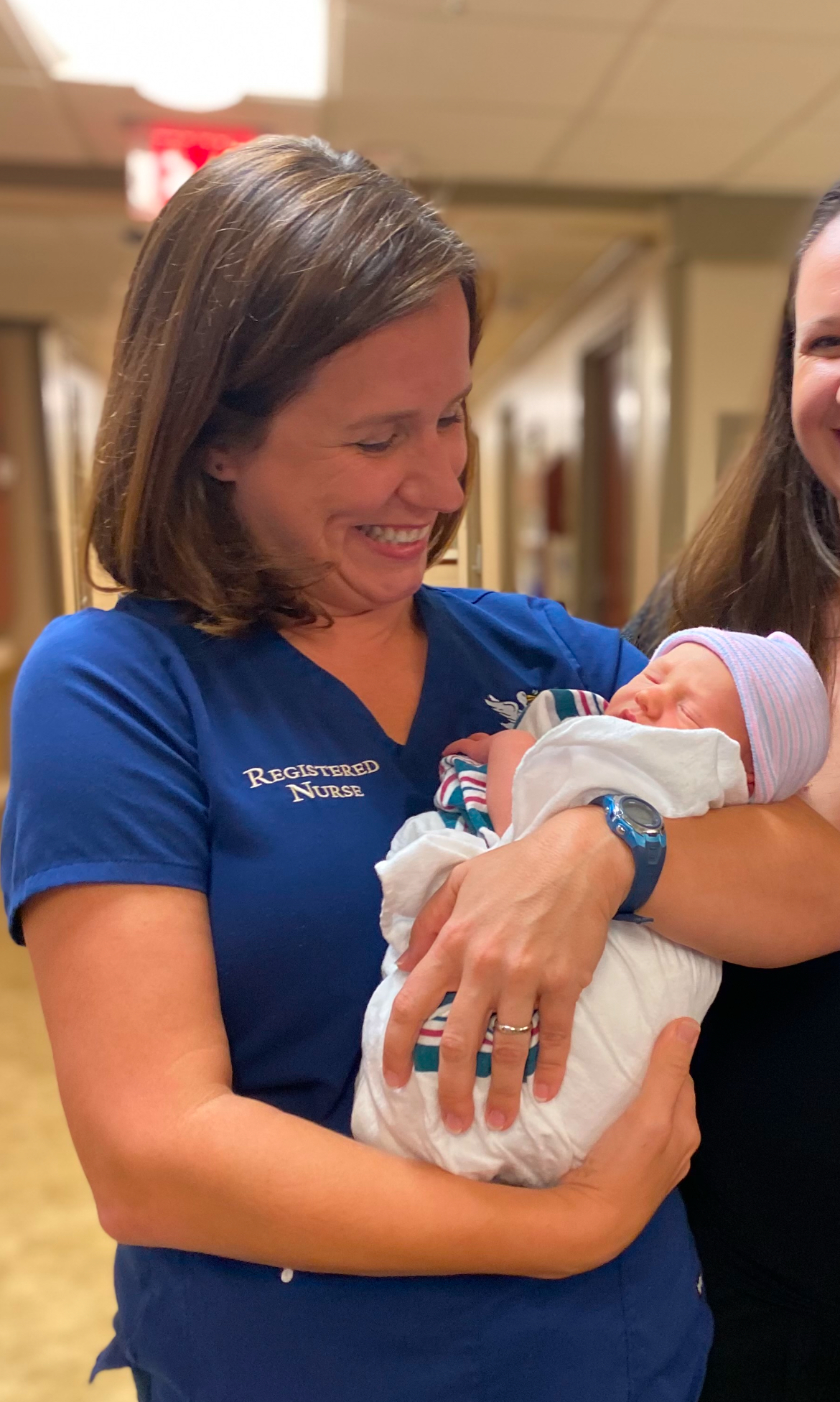 Nurse Katie Berra holding a baby