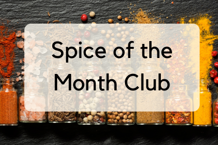 Jars of different spices open and spilling onto a table. Text overlap: Spice of the Month Club