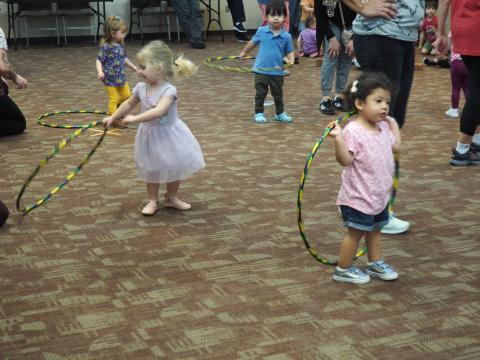 Toddlers playing with hula hoops