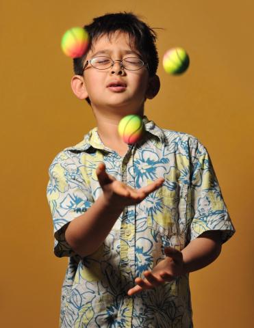 Young child juggling