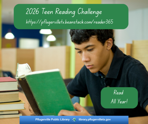Dark haired male teen reading a green book