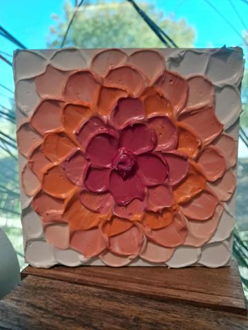 White, pink, and orange square flower painting with raised texture