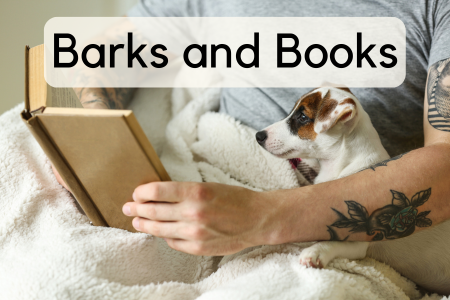 Man with tattoos reading with small brown and white dog on his lap