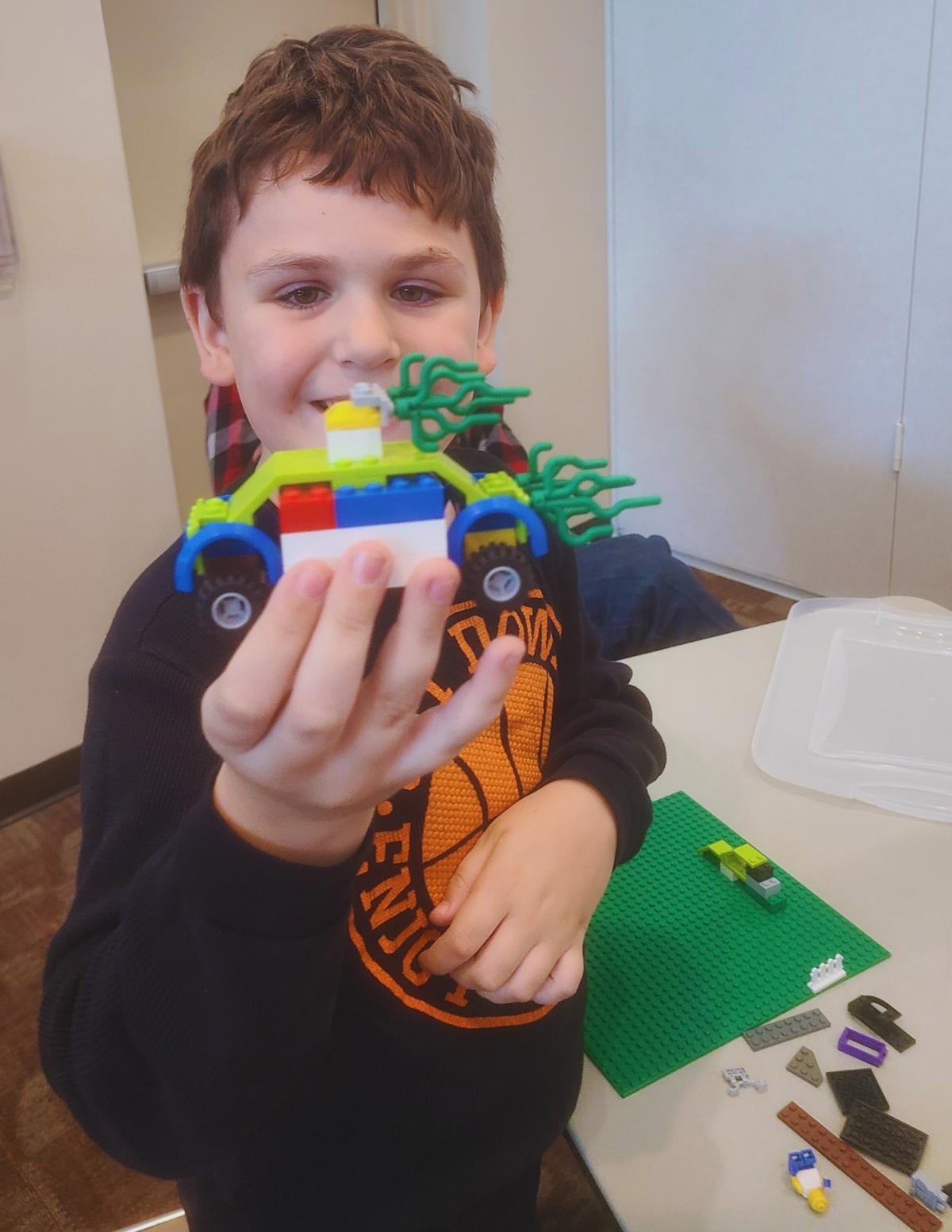 Young boy building with LEGO blocks