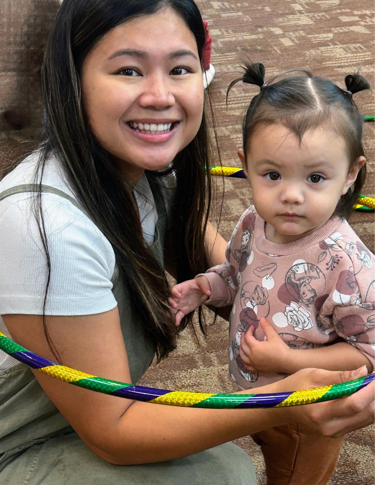 Mom and daughter playing with a hoola